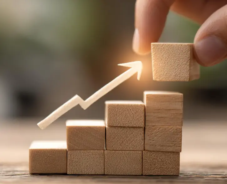 Facility Management Company Wooden blocks stacked as a growth chart with an upward arrow, symbolizing hard services growth.
